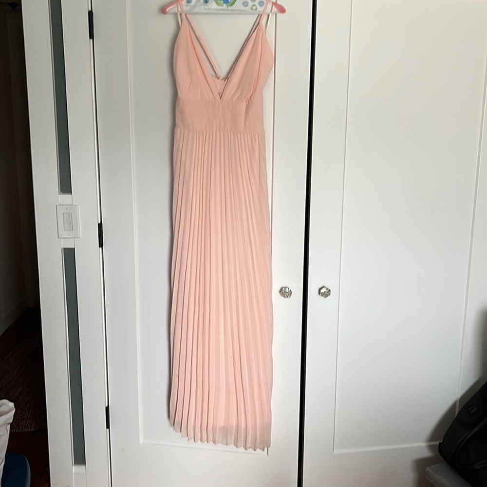 Bridesmaid dress by Lulus. Pastel pink, pleated, criss cross back